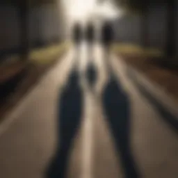 Silhouette of two figures walking in opposite directions with shadows stretching out