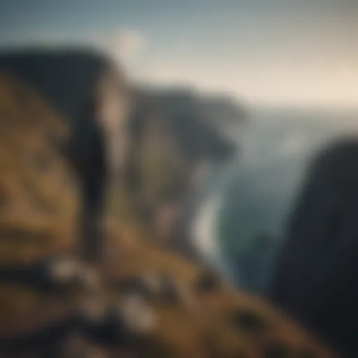 Person standing at the edge of a cliff looking towards the horizon