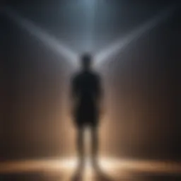 Silhouette of person standing under a ray of light