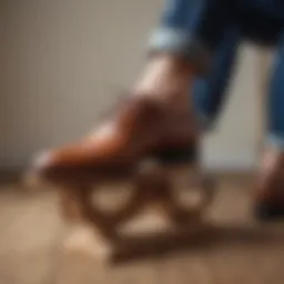 Pair of classic leather shoes being stretched with a wooden shoe stretcher